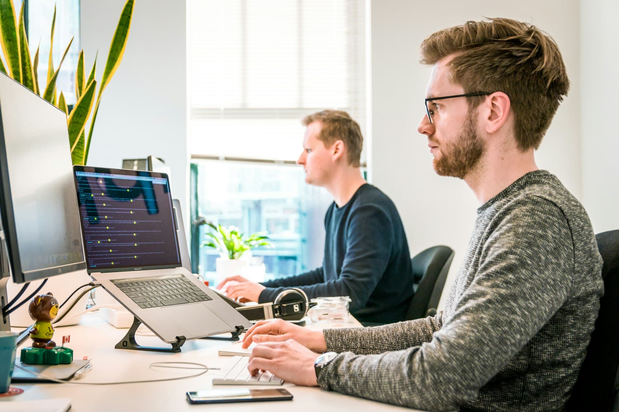 IT staff working at desks in a bright office
